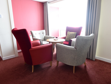 Table and four chairs in the corner of a communal area