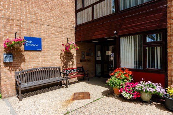 Main entrance of Hildesley Court with a bench and flowerpots outside