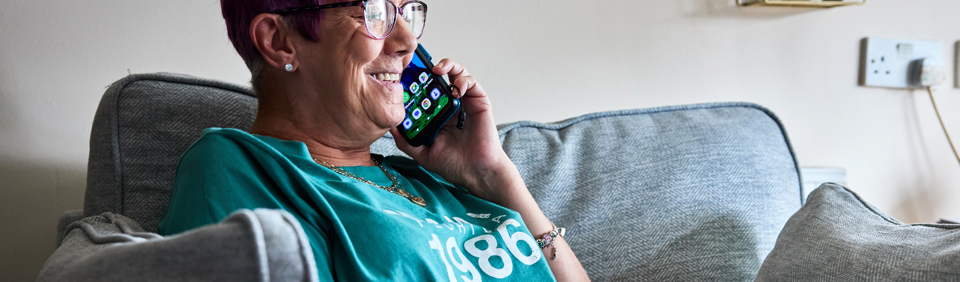 Resident sitting down taking a phone call  