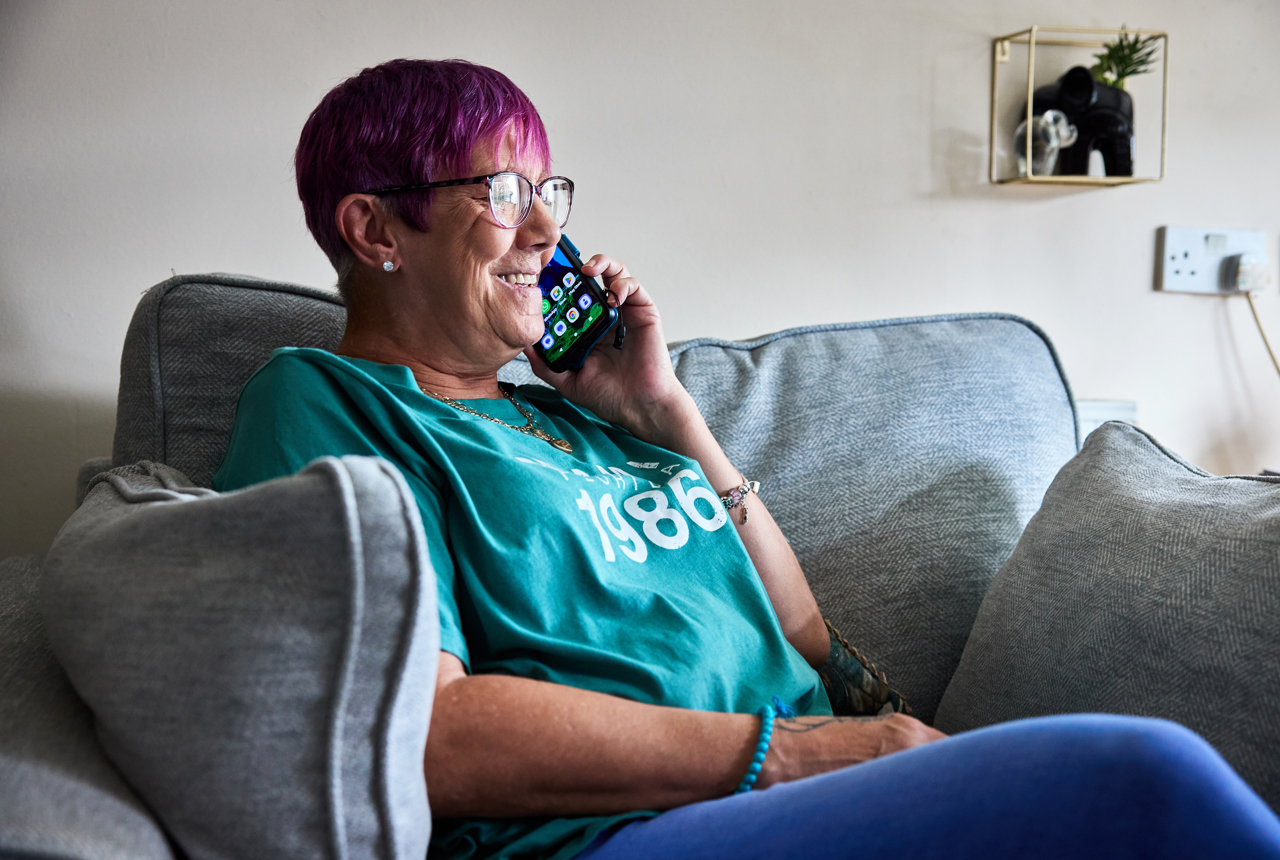 Resident sitting down taking a phone call 