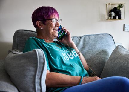 Resident sitting down taking a phone call