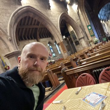 A man takes a selfie in a church