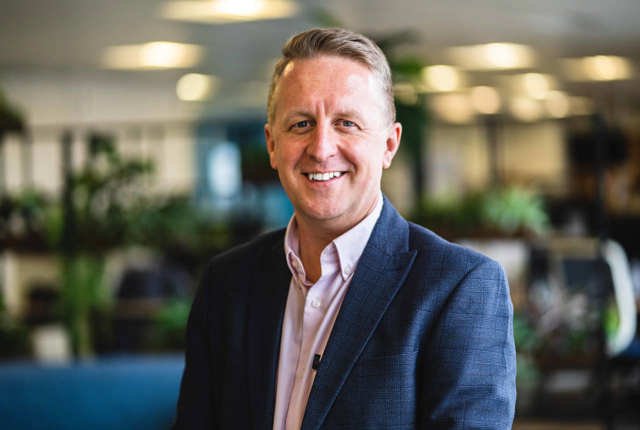 A man in a suit and open collar shirt