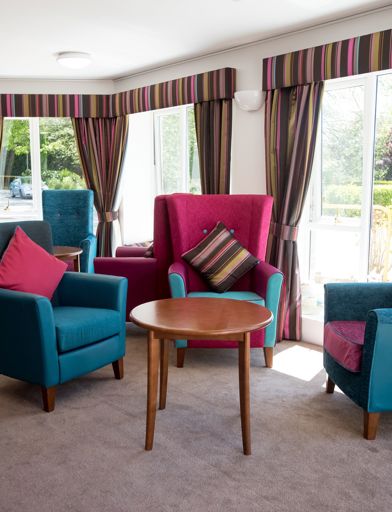 Residents' lounge with armchairs and tables 