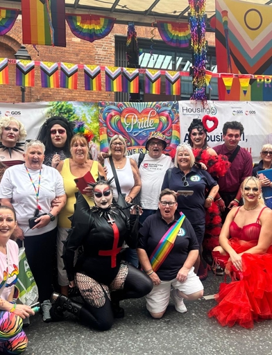 Housing 21 Employees And Residents At Manchester Pride 2025 In Front Of A Float 