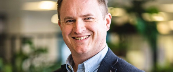 Andy Shaw, Chief Financial Officer of Housing 21, smiles into the camera