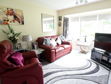 Inside the lounge of an apartment with sofa and TV