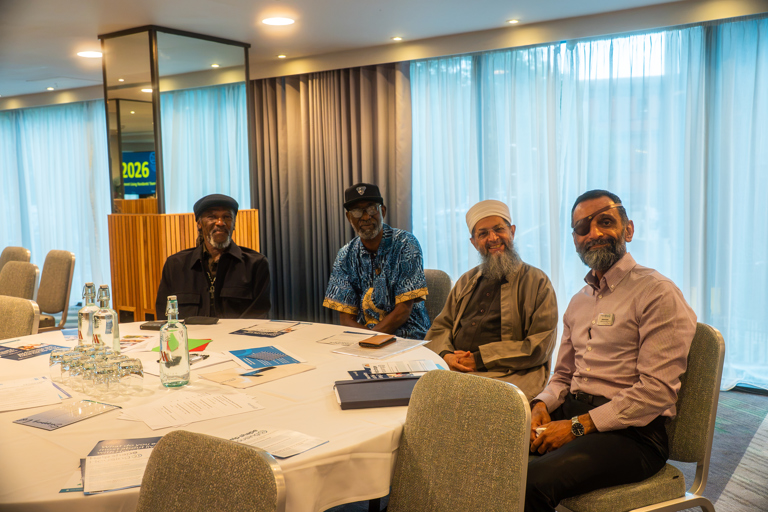 Three residents sitting at a conference with a Housing 21 surveyor