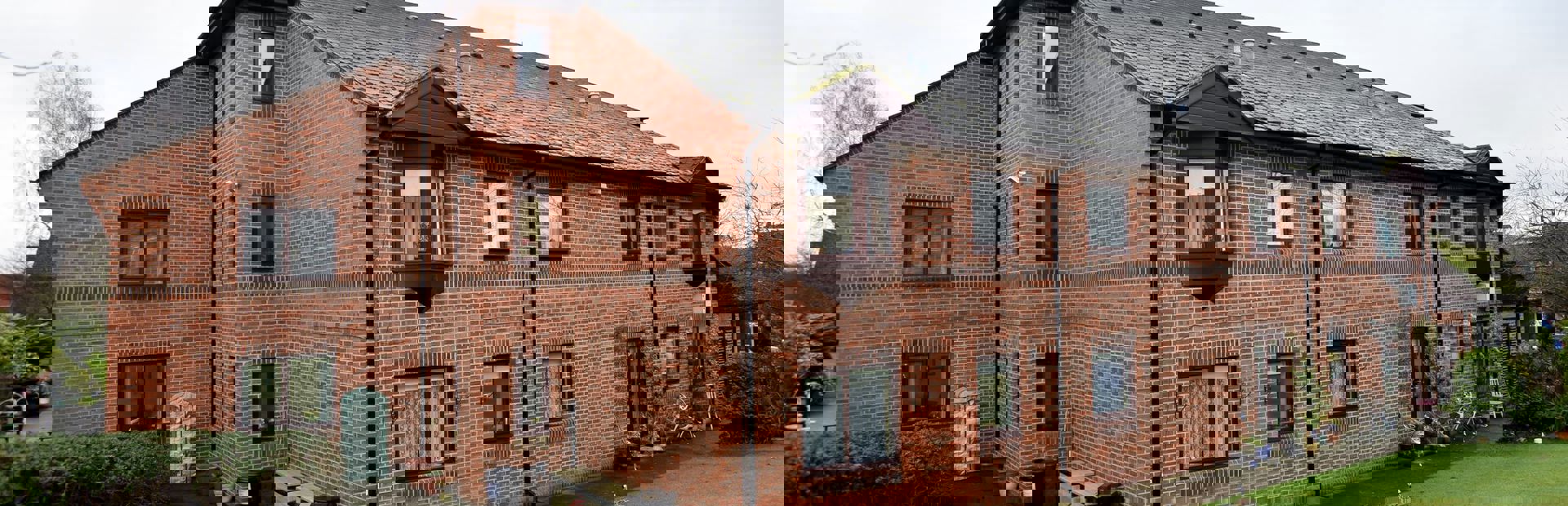 Communal outside space with large grassed area at Alan Hilton Court