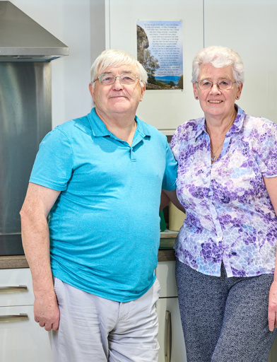 Extra Care stood in the kitchen in their apartment 