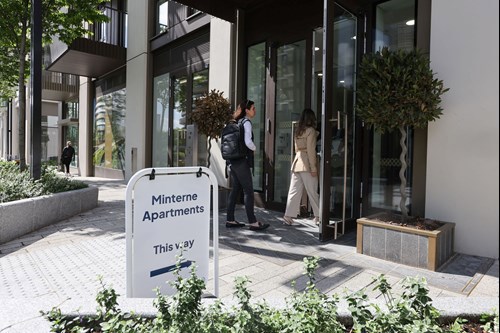 Visitors walking through the entrance door at Minterne Apartments