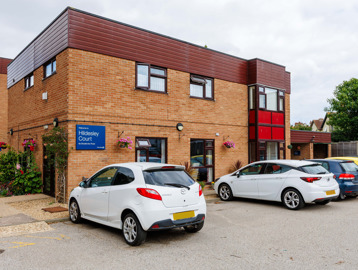 Exterior of Hildesley Court showing brick building and car park