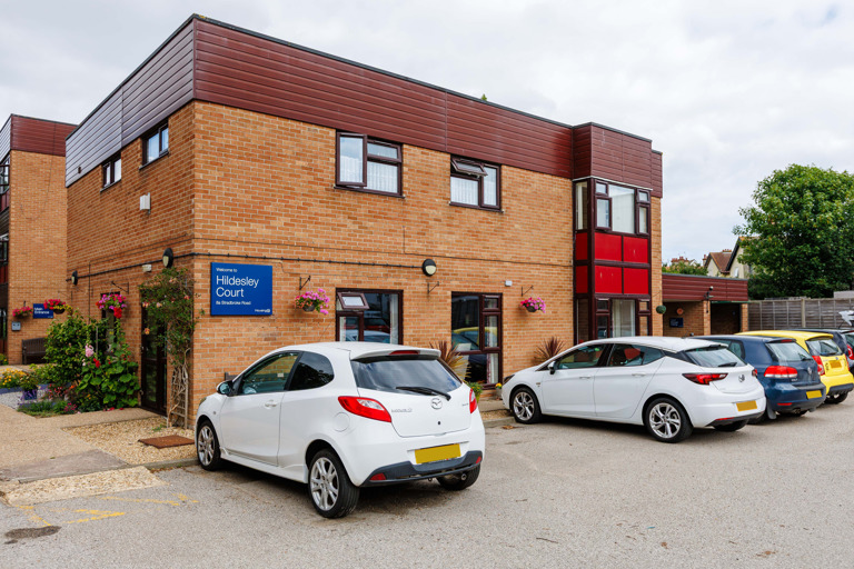 Exterior of Hildesley Court showing brick building and car park