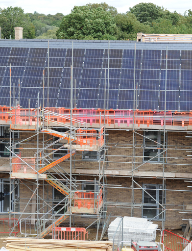 Development Roman Court in its topping out phase with PV panels on the roof 