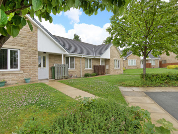 Grassed areas and pathways leading to the front of the bungalows