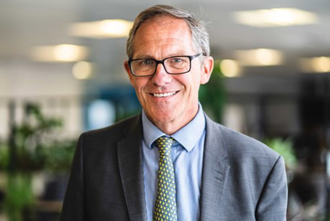 Chief Executive Bruce Moore looks into the camera and smiles 