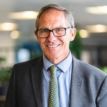Chief Executive Bruce Moore looks into the camera and smiles