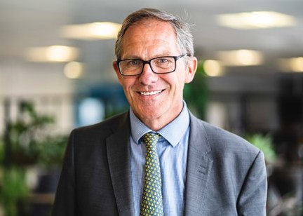 Chief Executive Bruce Moore looks into the camera and smiles