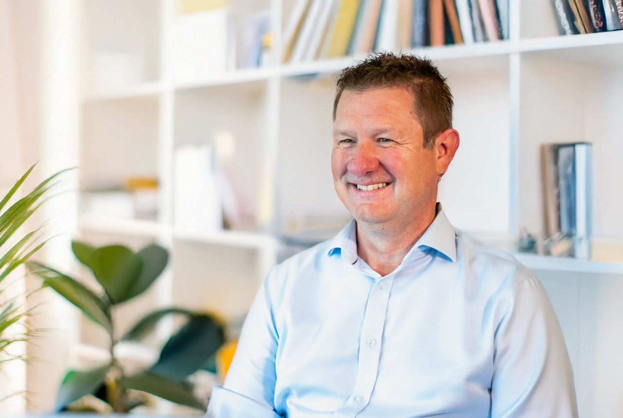 Man in pale shirt smiling 