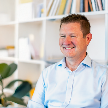 Man in pale shirt smiling