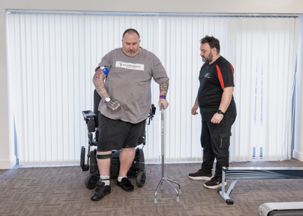 Chris, a Housing 21 resident, undertakes physiotherapy exercises under the supervision of his physio, Marc