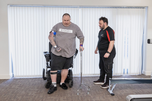 Chris, a Housing 21 resident, undertakes physiotherapy exercises under the supervision of his physio, Marc