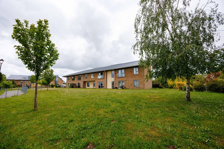 Green Lane View surrounded by landscaped grass area