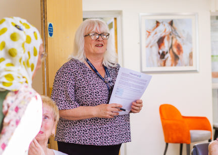 Local Housing Manager stood with a form about to talk to residents 