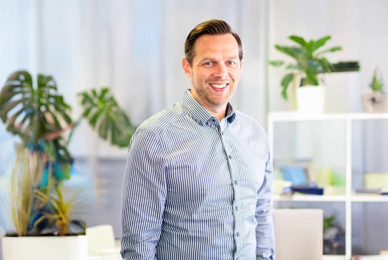 Man in striped short smiling 