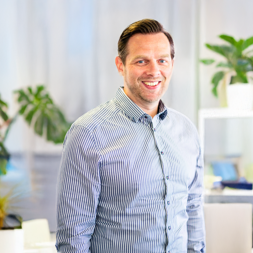 Man in striped short smiling