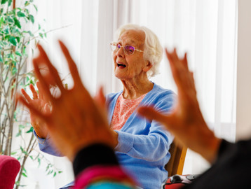 A resident singing during an activity at Mere View
