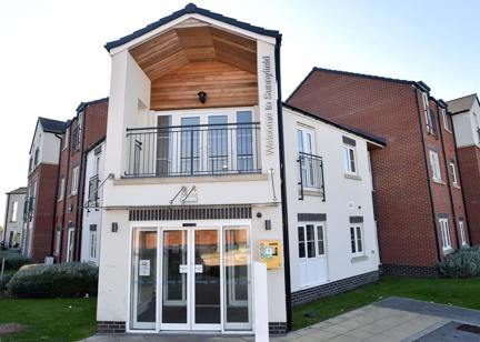 Main entrance to Sunnyfield Court with grassed areas either side