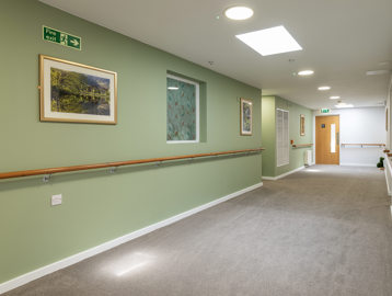 A green hallway with railings