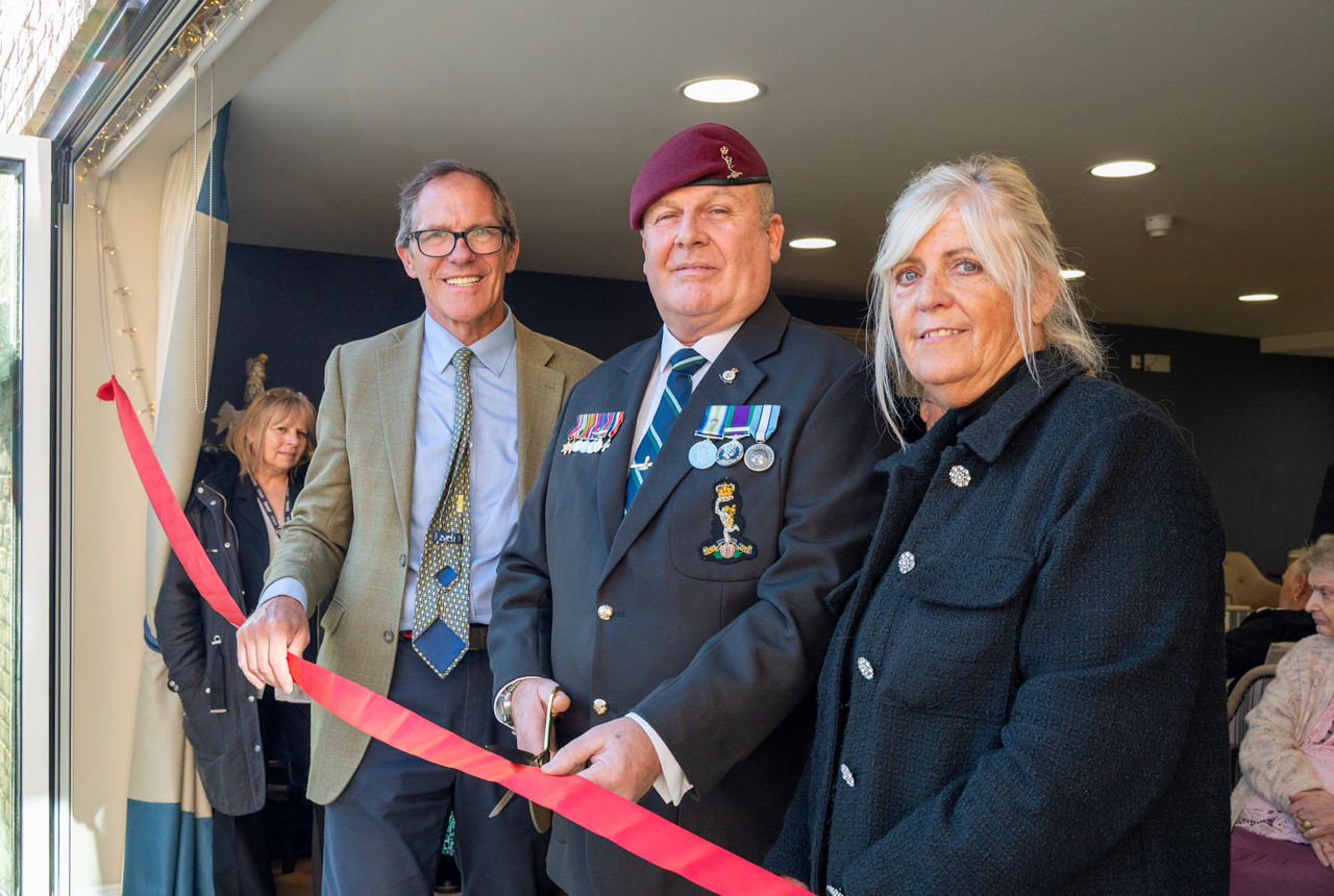 Housing 21's Chief Executive Bruce Moore with a Local Housing Manager and Resident doing a ribbon cutting