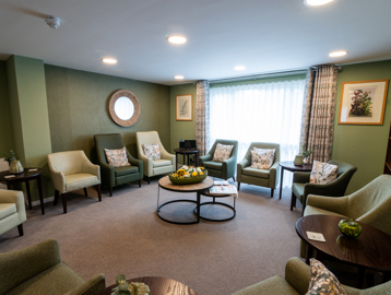Modern and clean communal lounge with green decor