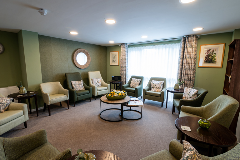 Modern and clean communal lounge with green decor