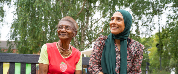 Two women smile into the distance