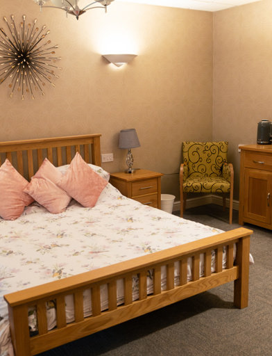 A double bed with wardrobe side tables and soft furnishings in the guest room 
