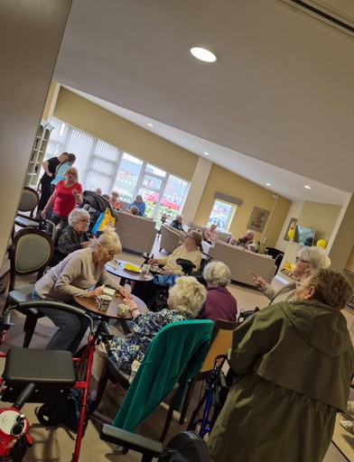 Residents in the communal lounge taking part in activities 