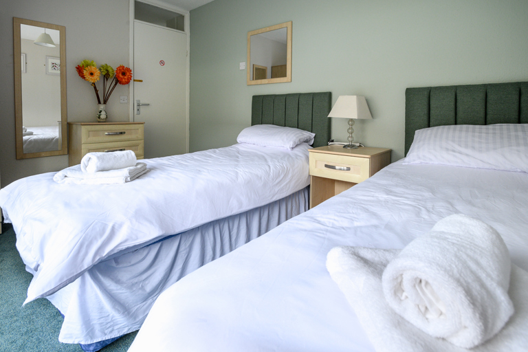 Twin bedroom with white duvet sets