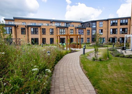 A photo of the pathway leading through the gardens of Poppy Gardens