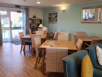 Dining area with tables and chairs in a bright kitchen area