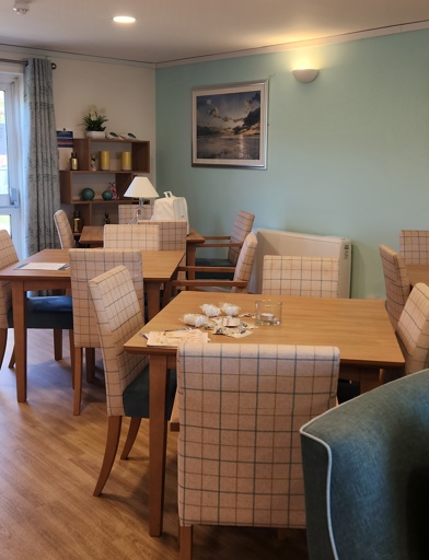 Dining area with tables and chairs in a bright kitchen area 
