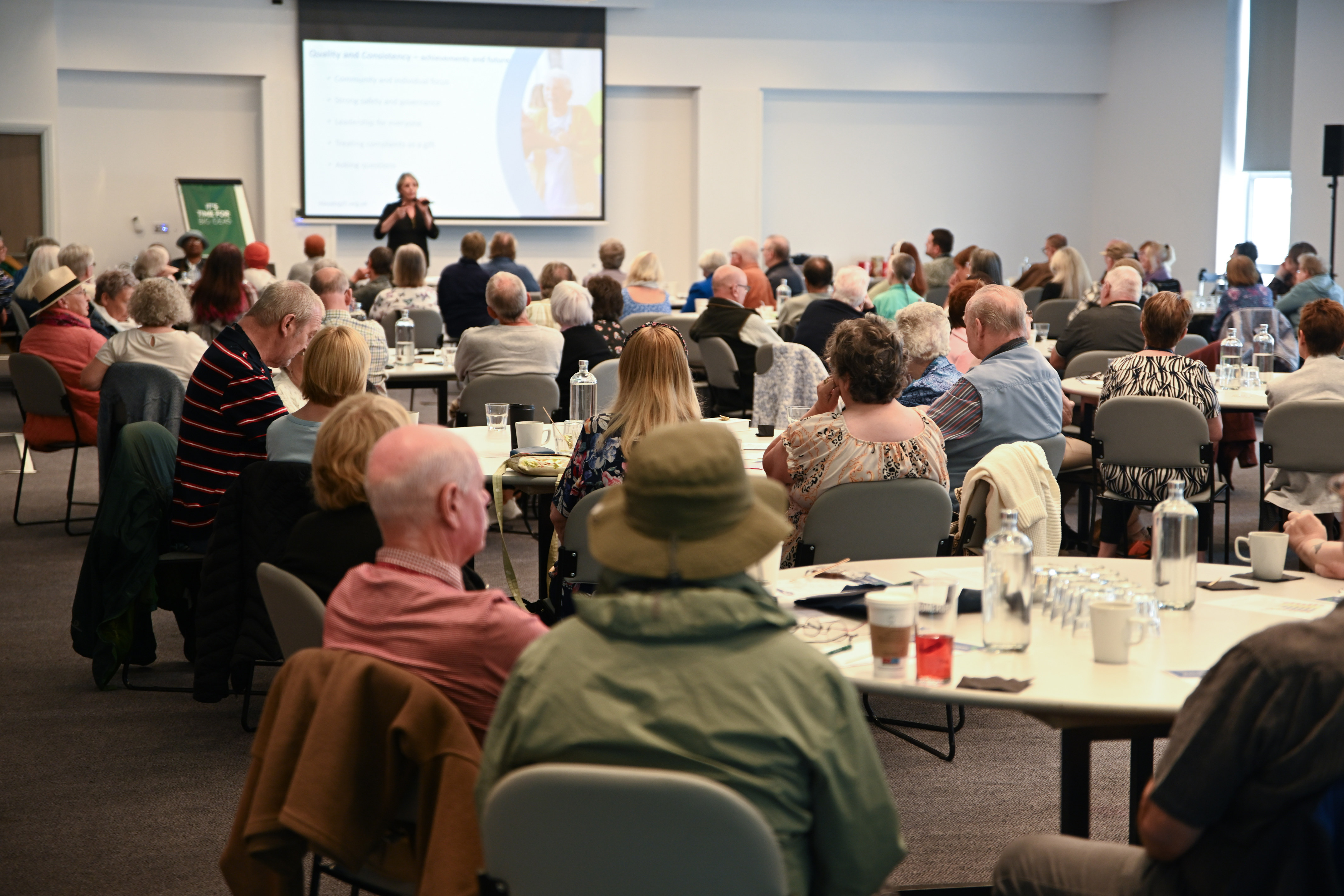 A room full of residents watching a presenter