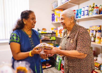 Two residents in a shop holding food