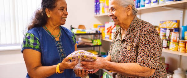 Two residents in a shop holding food