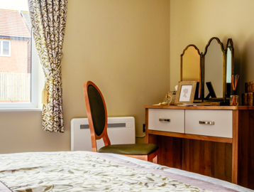 Inside the show home bedroom with make-up table, seat and mirror