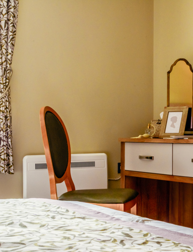 Inside the show home bedroom with make-up table, seat and mirror 