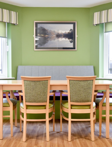 Communal dining table inside Acre Court with green painted walls