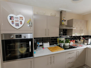 A bungalow kitchen with beige cupboards